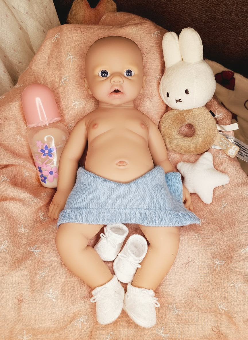 muñeco con peluche sobre manta rosa